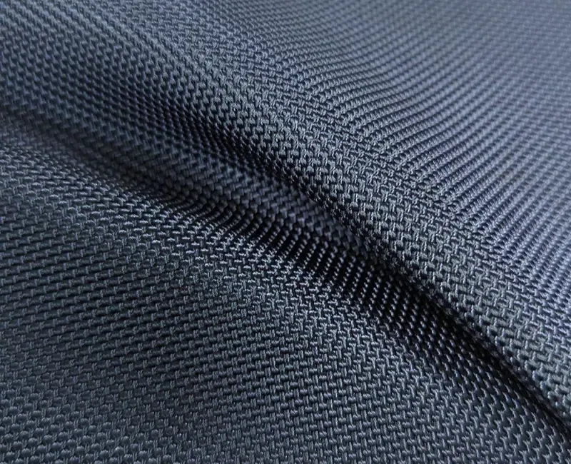 A close view of black ballistic nylon cloth, the basket weave filling the frame