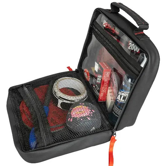 An open black accessory case with mesh, elastic loops and small bottles held in place inside a zipped lid