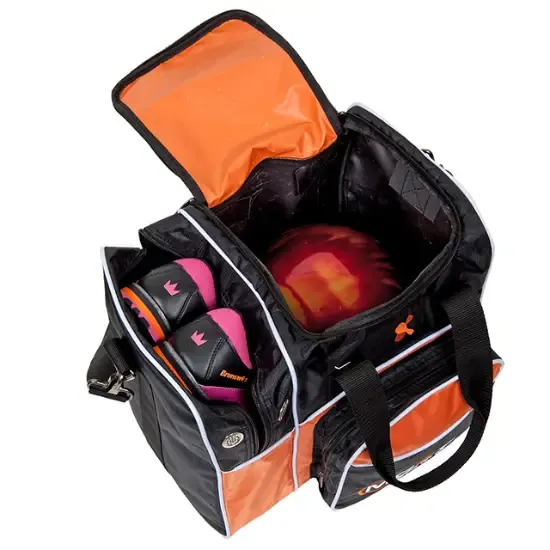 An open bowling bag in black and orange with a single ball sitting in its well and a pair of shoes held in a side compartment