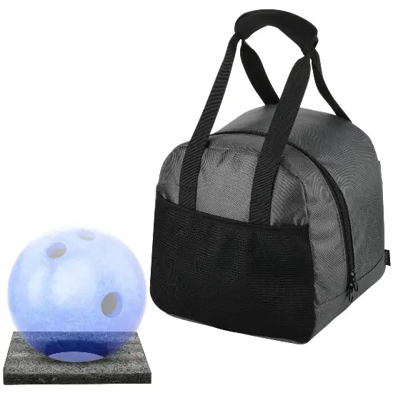 A soft grey bowling tote with black webbing handle and a single blue ball set on a floor plate beside it