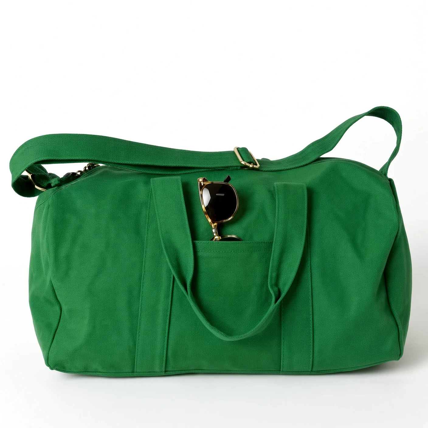 A green canvas duffle bag with navy rope handles and an open front slip pocket, shown on a white ground