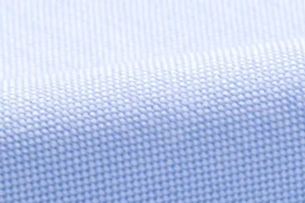 A close view of pale blue Oxford cloth showing its basket weave