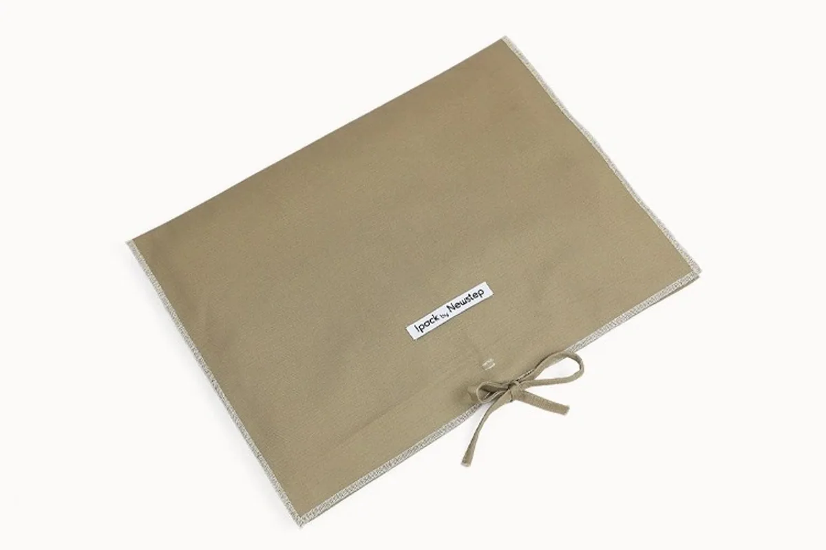 A custom canvas flap dust bag with a tie closure