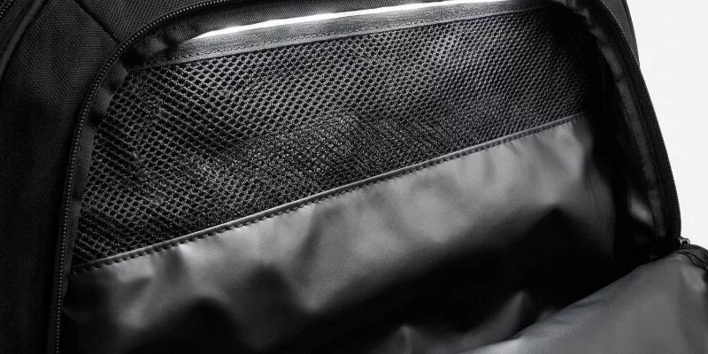 Gym bag shoe compartment interior featuring breathable mesh vent and waterproof TPU lining.