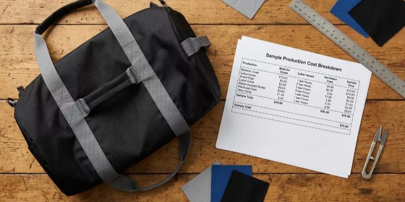 Transparent sample production cost breakdown sheet next to a custom gym bag.