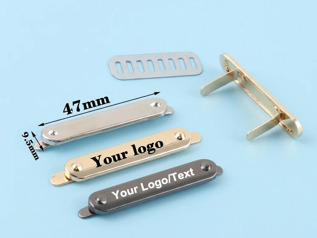 Metal logo plates and a cast metal frame fitting in silver, gold and gunmetal finishes
