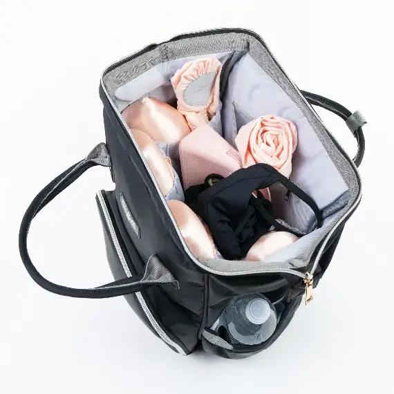 A black bag opened wide to show a pale grey lining divided into slip pockets, packed with soft rolls