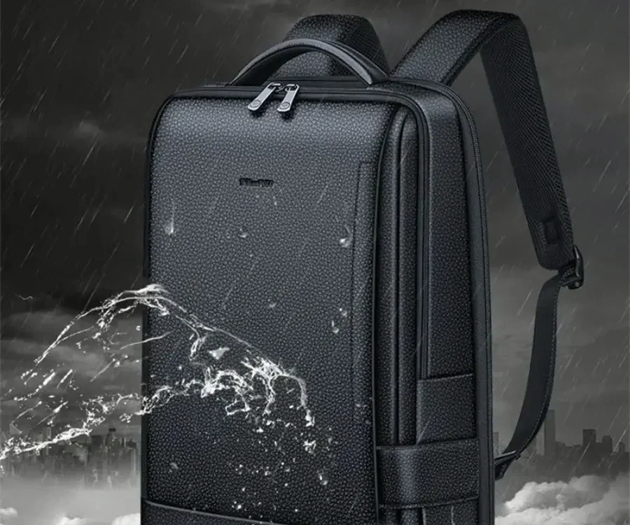Water beading and sheeting off the pebbled surface of a black leather backpack in the rain