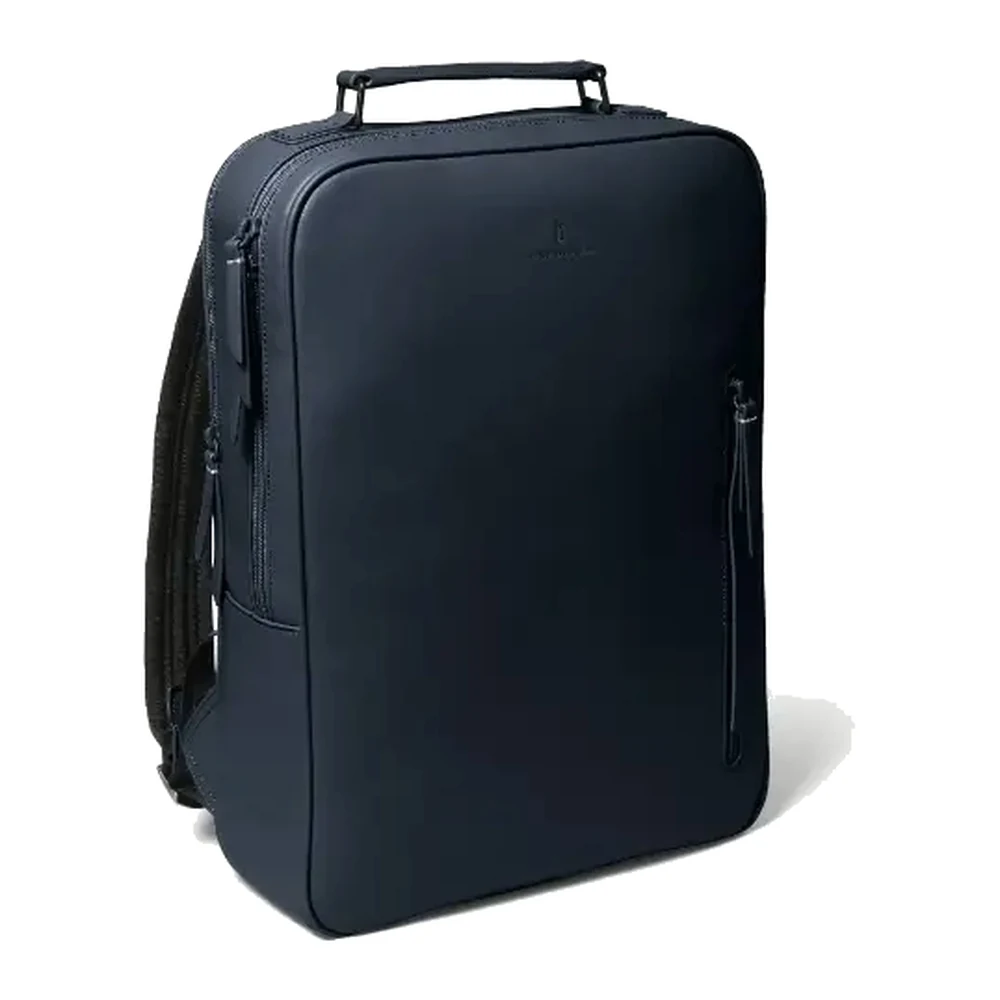 A navy minimal leather laptop backpack standing upright with a clean unbroken front panel, a single top handle and one slim side zip