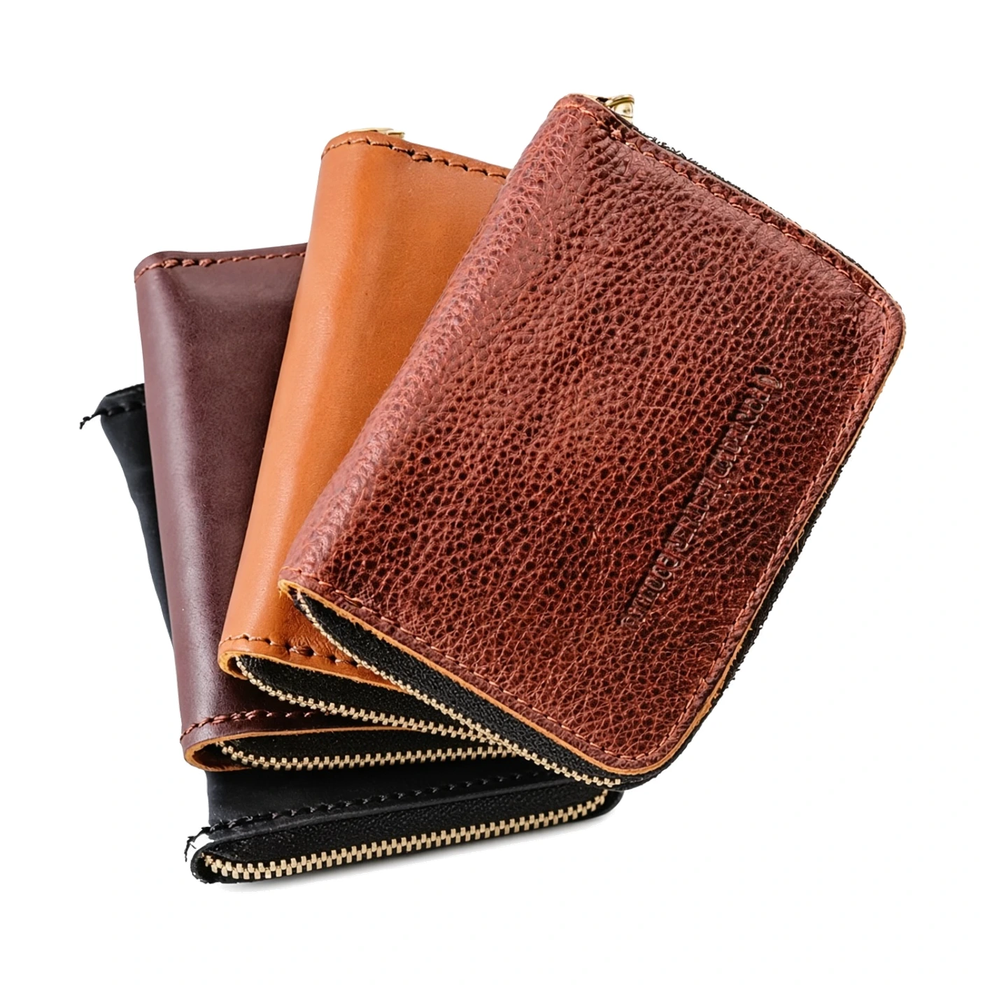 A stack of stitched zip-around leather wallets fanned in black, brown and tan