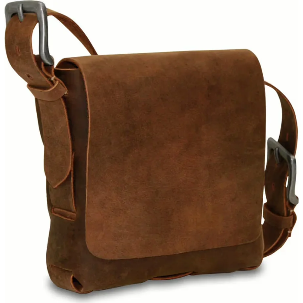 A brown suede messenger bag under a buckled flap strap with brass fittings, carried on a long strap