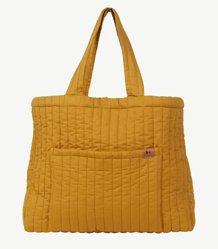 A mustard-yellow channel-quilted promotional tote with a front slip pocket and self-fabric handles