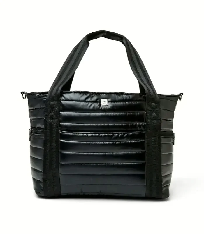 A black quilted commuter tote with a zip top, webbing handles and a side pocket