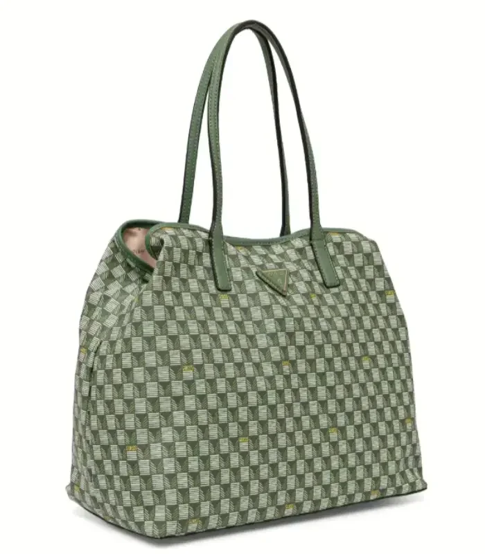 A sage-green quilted travel tote with long woven handles and a wave-finished face