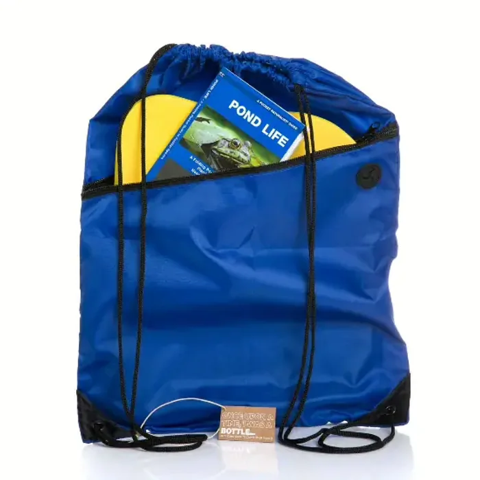 A royal-blue outdoor pack with a top drawcord, a buckle flap and a wet front pocket holding a book