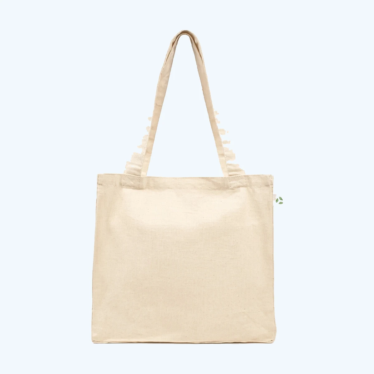 A natural undyed cotton canvas tote bag with long self-fabric handles