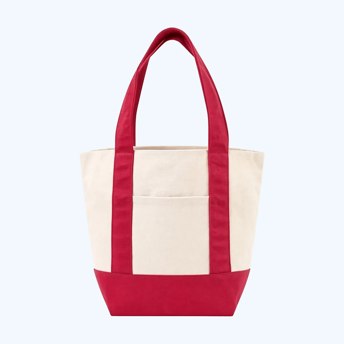 A cream canvas tote bag with a red contrasting base and red webbing handles