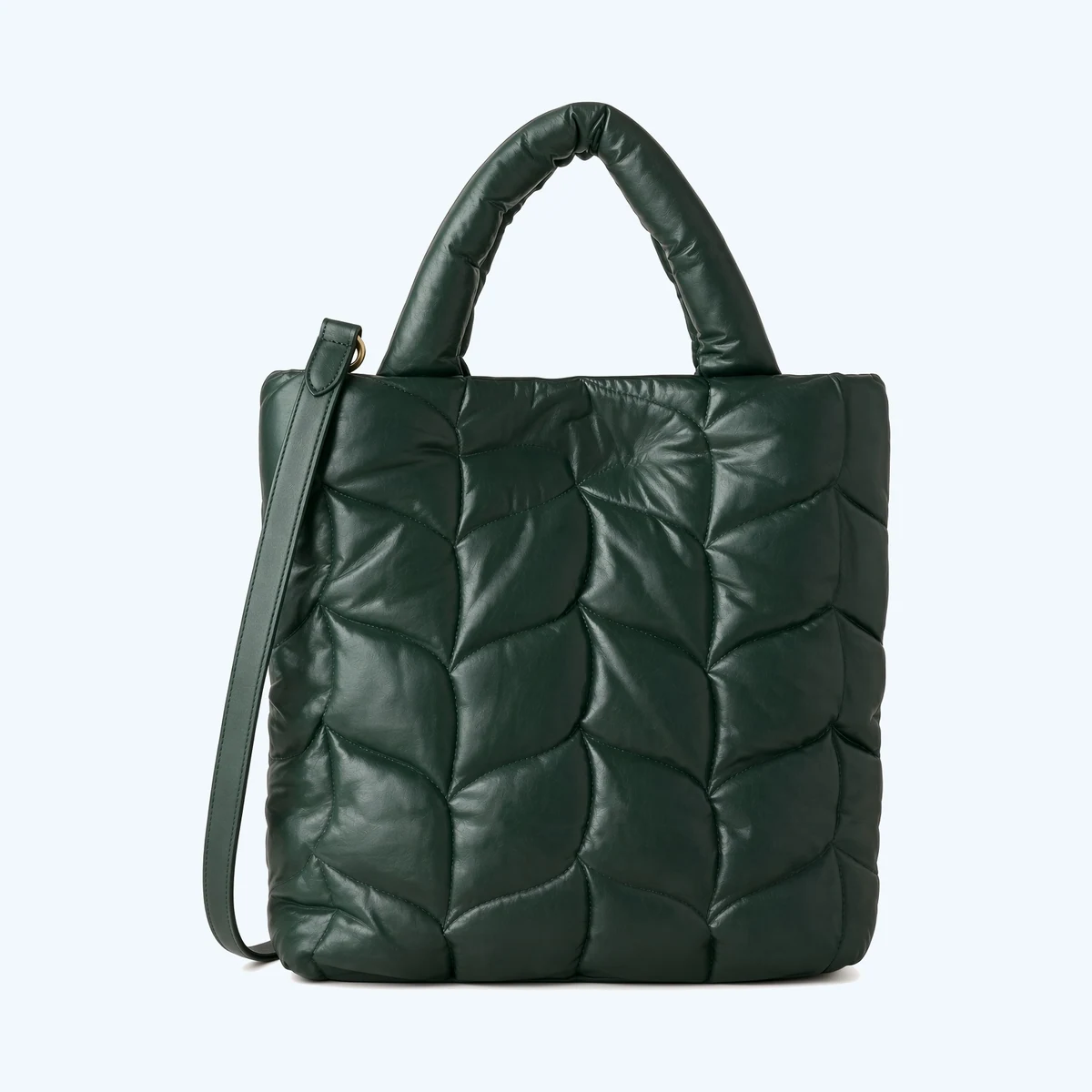A dark green quilted tote bag with a padded top handle and a detachable shoulder strap