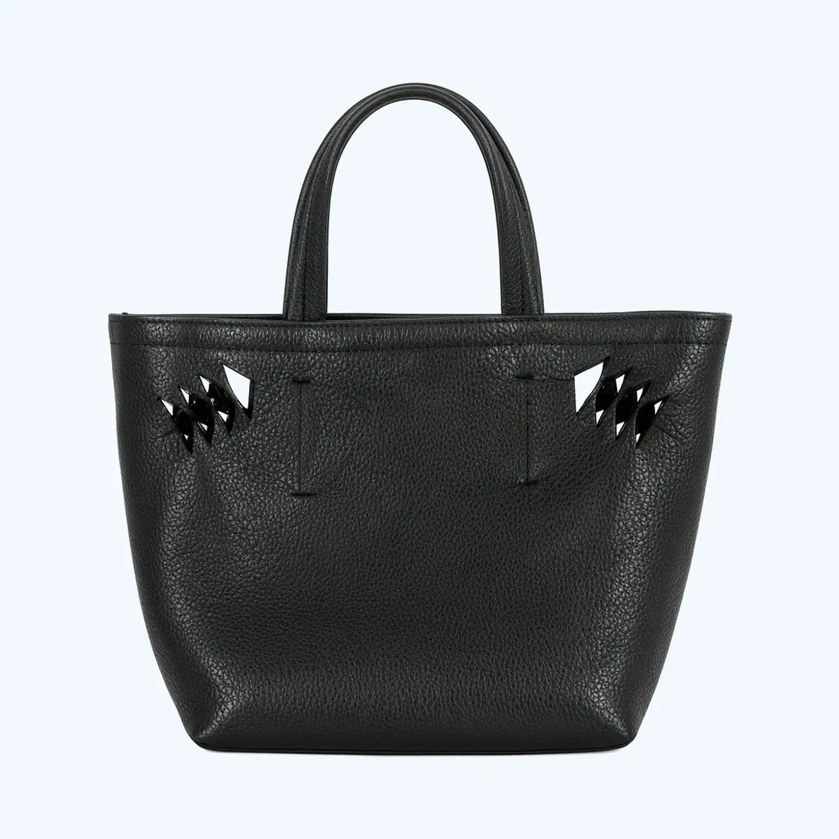 A small black leather tote bag with a top handle and studded side panels, made as a custom sample