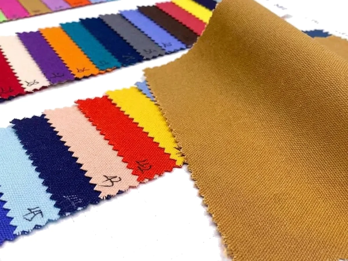 A cotton canvas fabric swatch fan beside a woven canvas panel