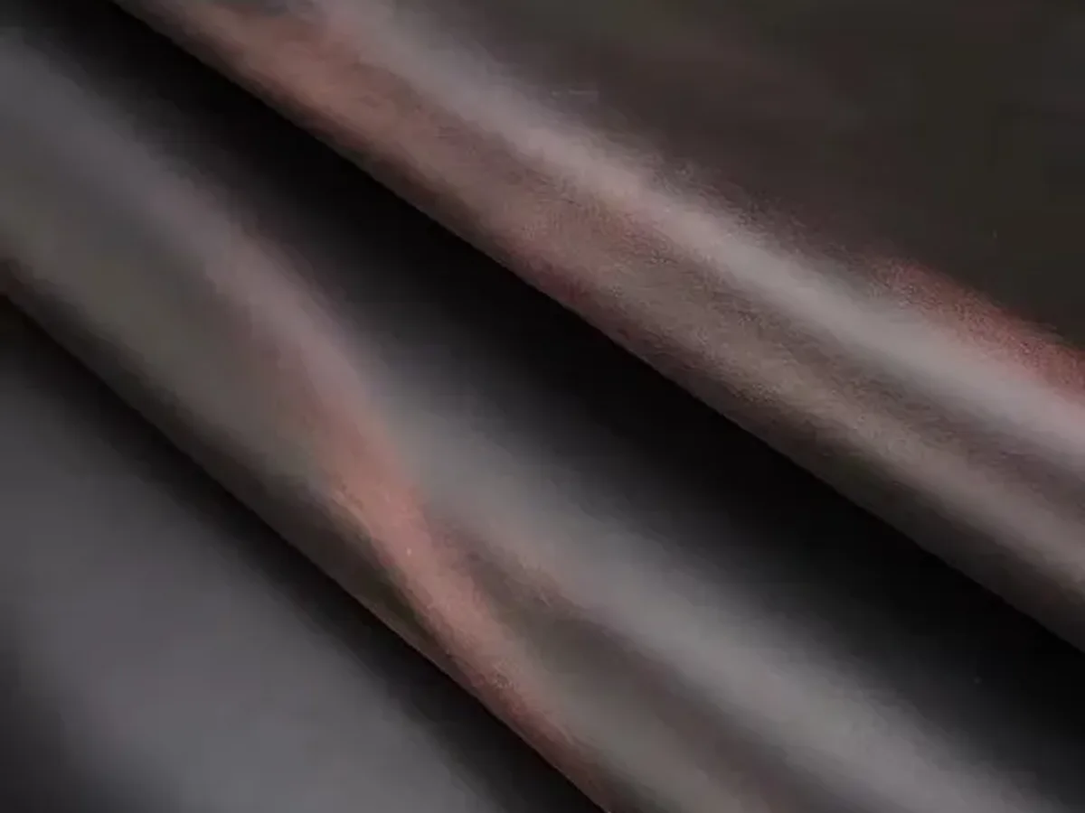 A polished leather hide photographed close enough to show its grain and sheen