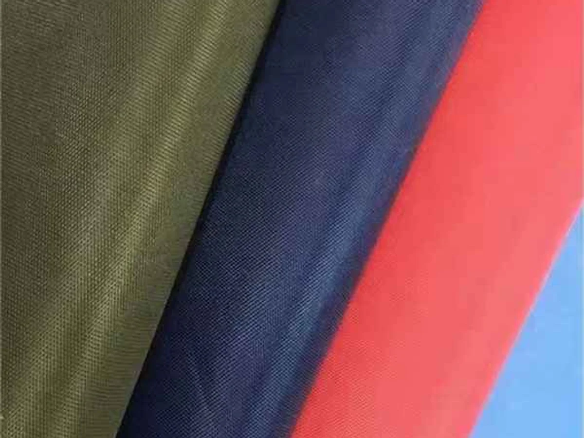 RPET recycled fabric fan-folded in several colours beside a clear pouch