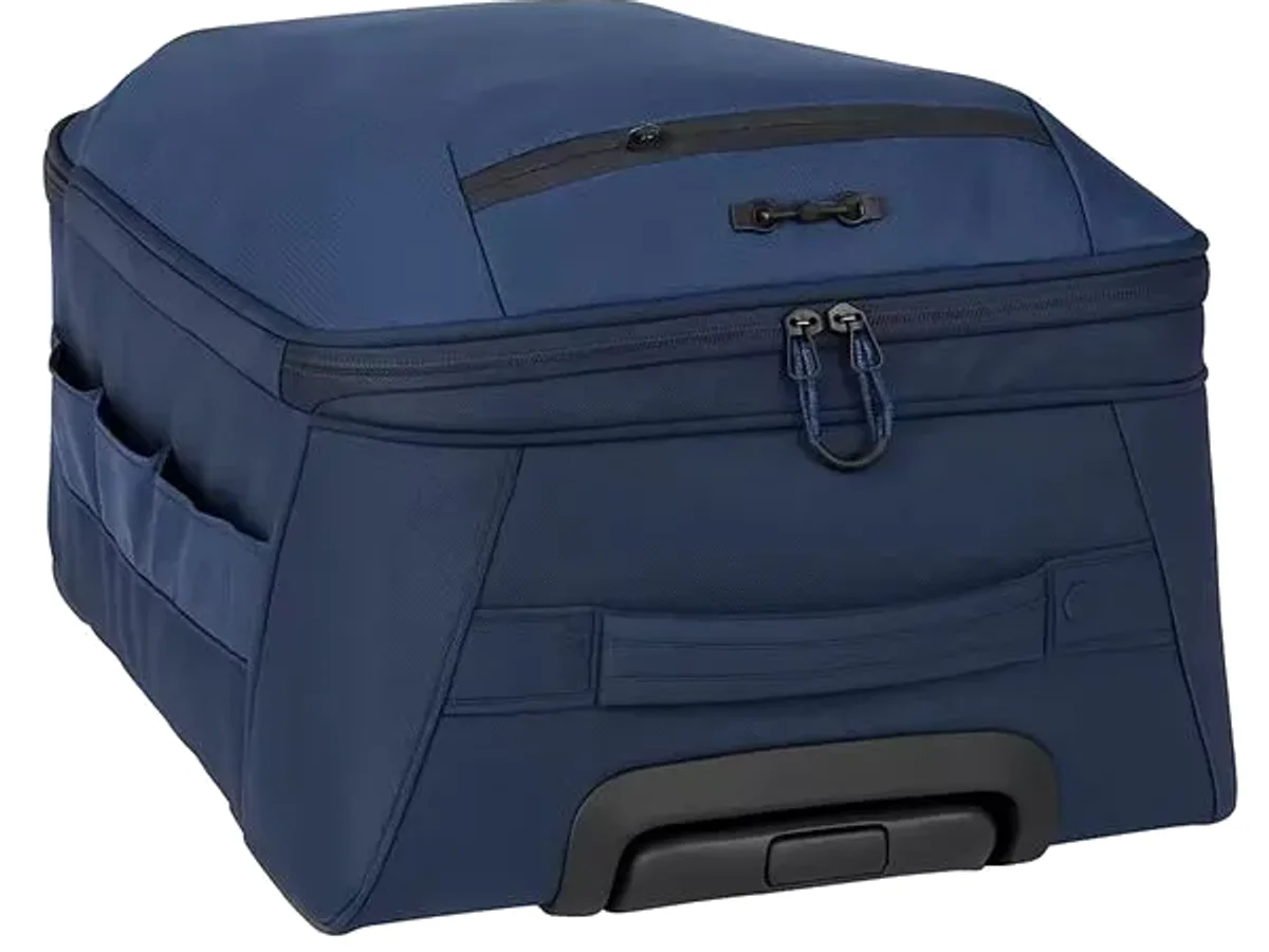 A navy RPET recycled travel case with a wheeled base on a plain ground