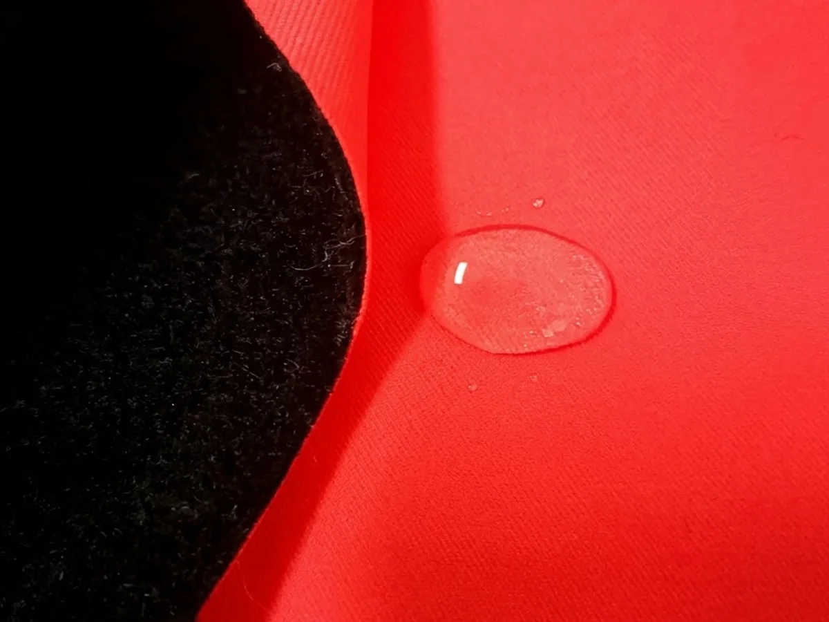 A waterproof coated tarpaulin face photographed close enough to show water beading on it