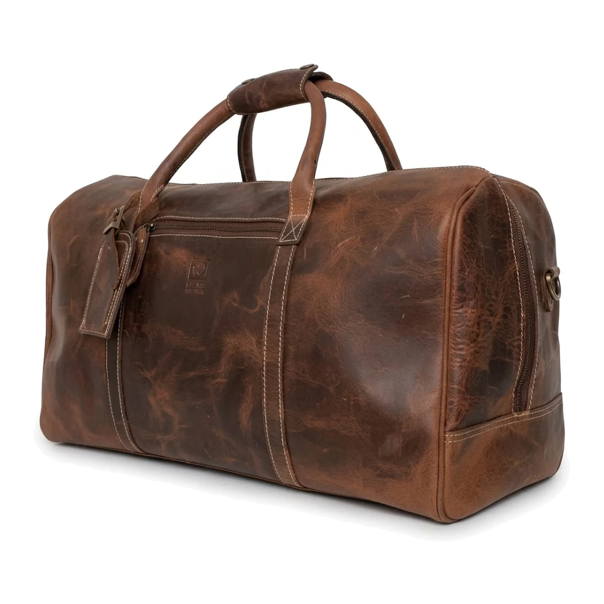 A custom leather travel bag with stitched handle roots and a leather-bound base, on a white ground